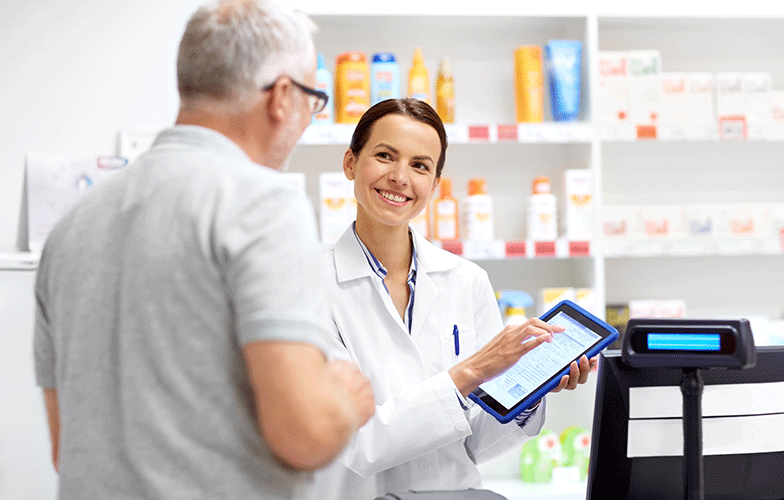 Pharmacist and customer looking at table in a pharmacy