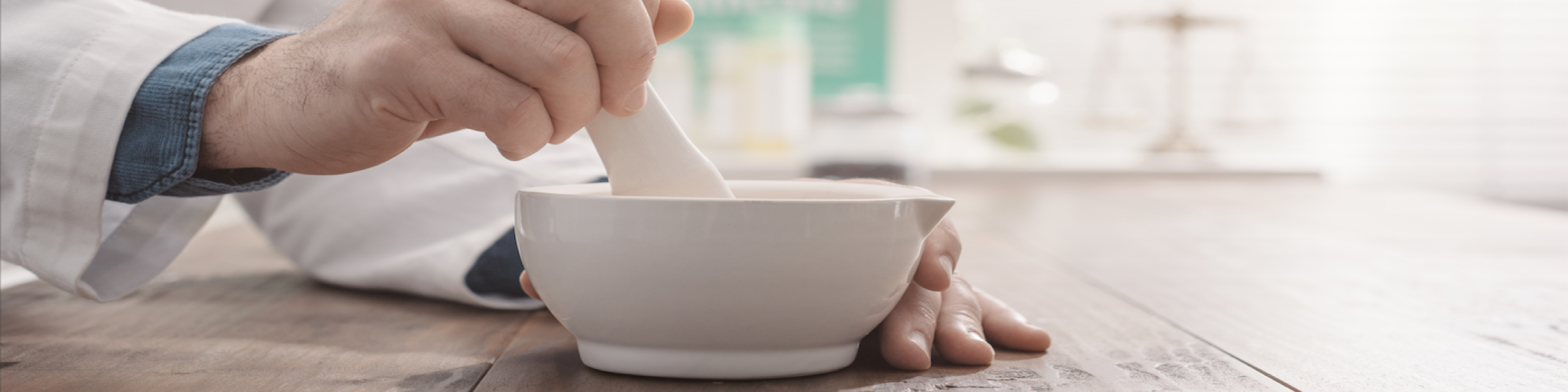person mixing medication with mortar and pestle